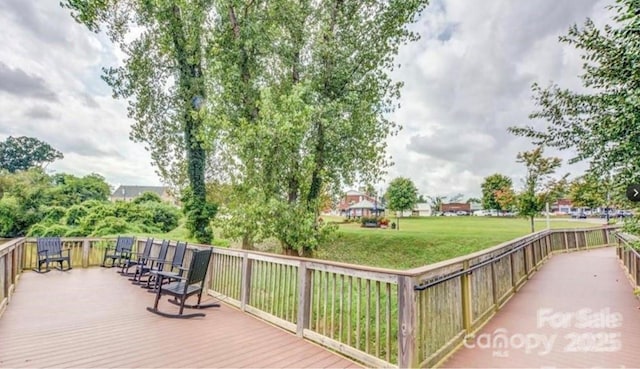 wooden deck with a lawn