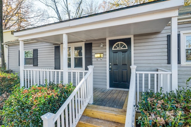 view of exterior entry with a porch