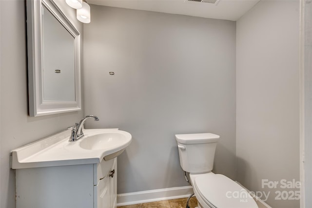 bathroom with tile patterned floors, toilet, and vanity