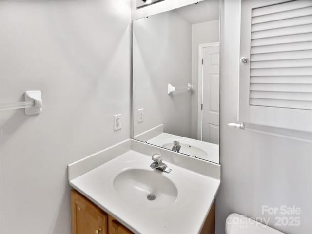 bathroom with toilet and vanity