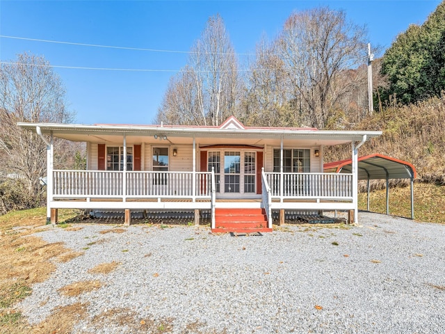 view of front of house featuring a porch and a carport