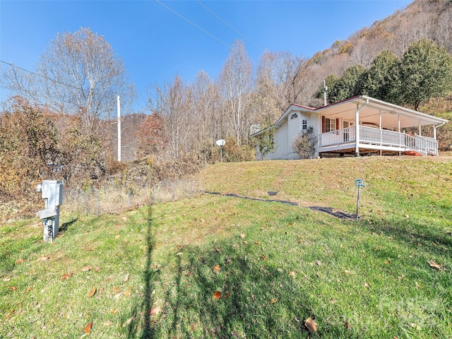 view of yard featuring a porch and a mountain view