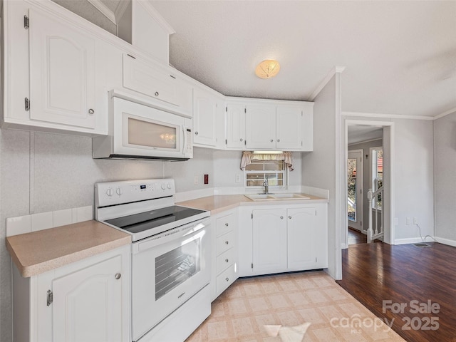 kitchen featuring white cabinetry, sink, white appliances, and ornamental molding