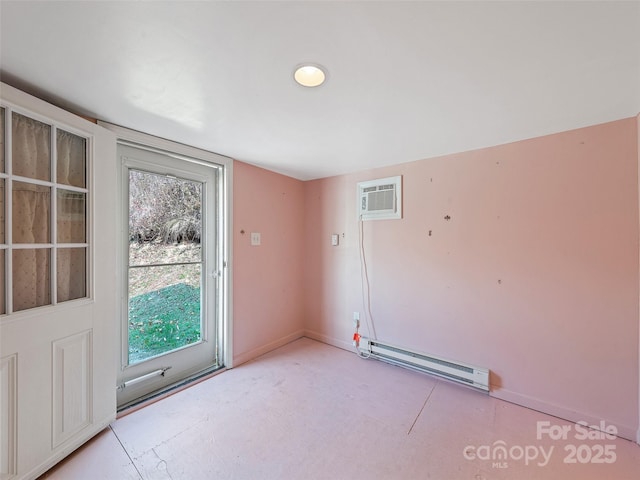 entryway featuring baseboard heating, a wall unit AC, and a wealth of natural light