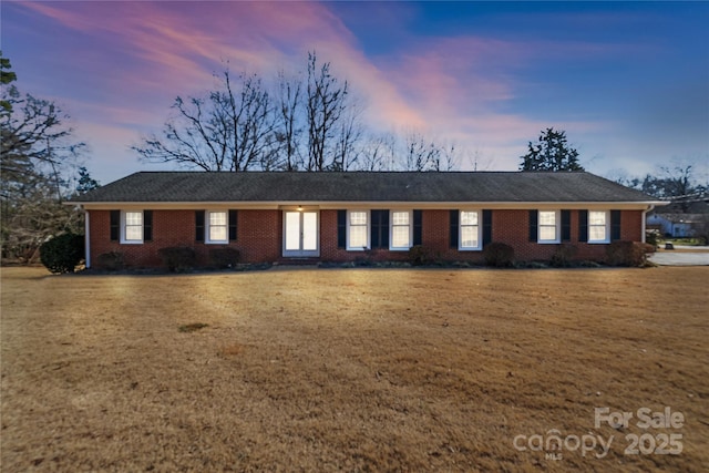 ranch-style house with a yard