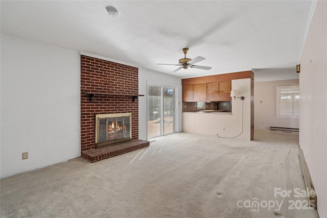 unfurnished living room with ceiling fan, light colored carpet, a fireplace, ornamental molding, and a baseboard radiator