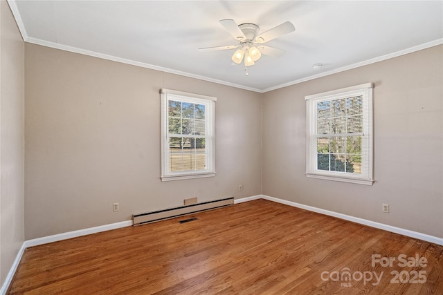 empty room with ceiling fan, wood-type flooring, ornamental molding, and a baseboard radiator