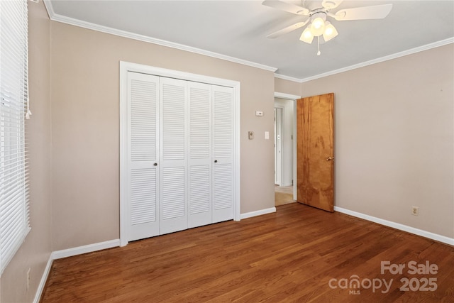 unfurnished bedroom featuring ceiling fan, ornamental molding, a closet, and wood-type flooring