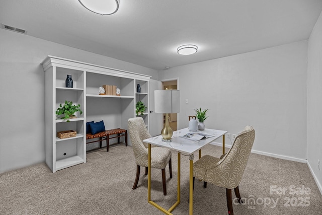 carpeted dining space with visible vents and baseboards