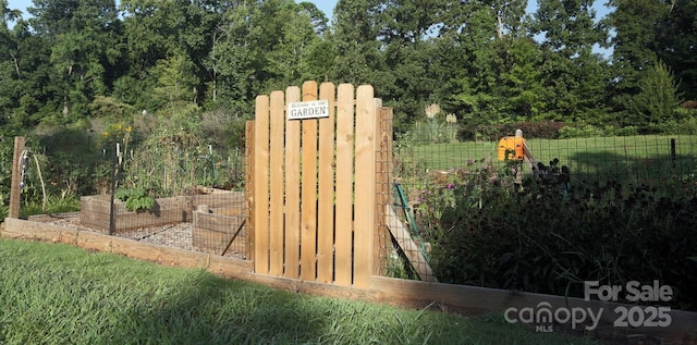 exterior details featuring a garden and fence