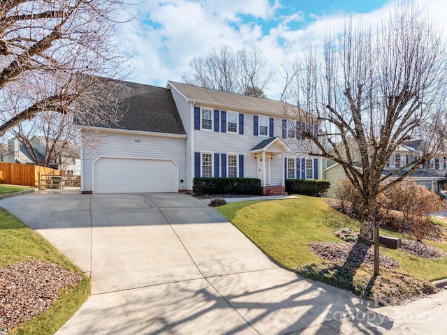 view of front of property with a garage and a front yard