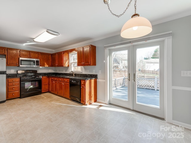 kitchen with pendant lighting, black appliances, crown molding, and french doors