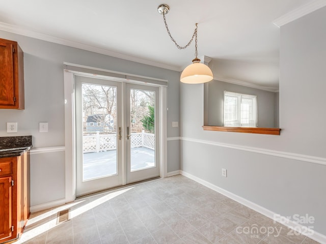 interior space with crown molding and french doors