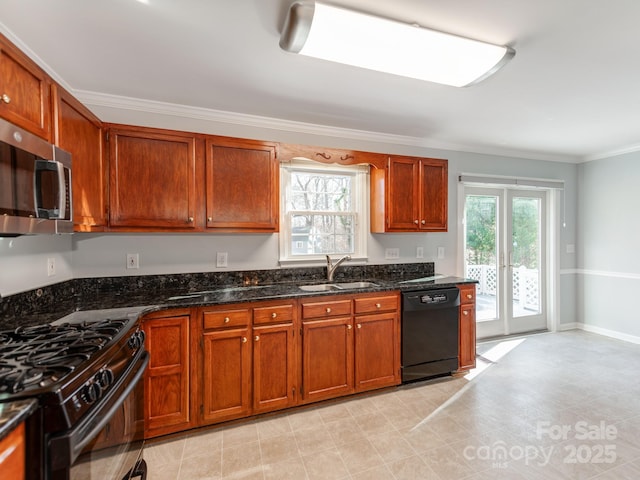 kitchen featuring sink, black appliances, plenty of natural light, and dark stone countertops