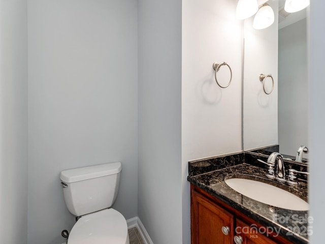 bathroom featuring toilet and vanity