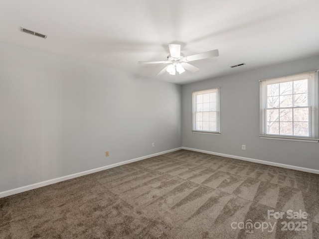 carpeted empty room featuring ceiling fan