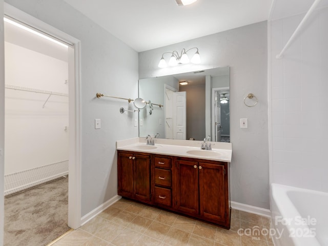 bathroom featuring a tub to relax in and vanity