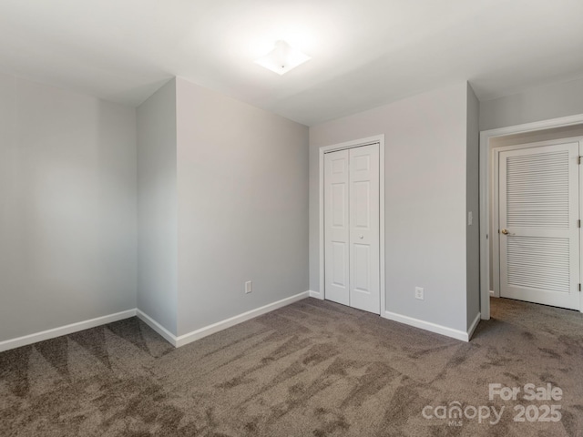 unfurnished bedroom featuring carpet floors and a closet