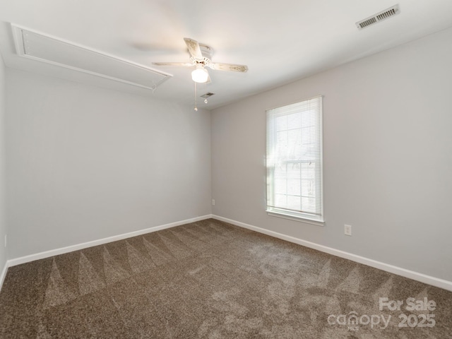 unfurnished room with ceiling fan and carpet