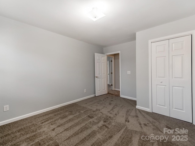 unfurnished bedroom with a closet and carpet flooring