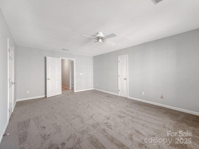 unfurnished room with ceiling fan and carpet flooring