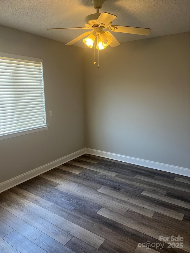 spare room with ceiling fan, dark hardwood / wood-style flooring, and a textured ceiling