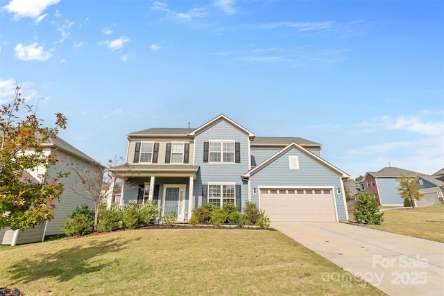 view of front of house featuring a garage, a front lawn, and covered porch