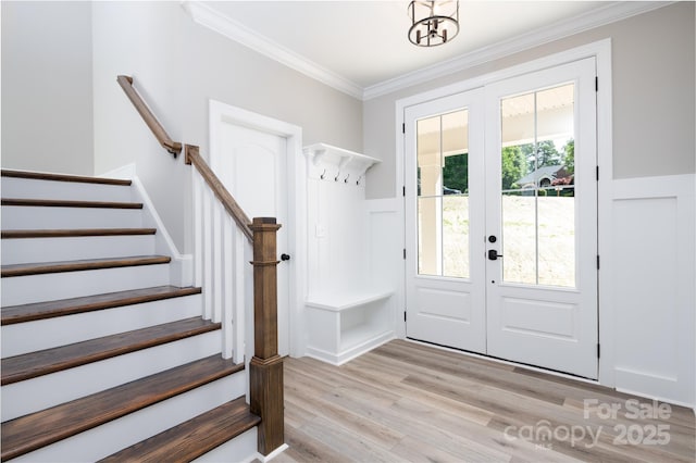 mudroom featuring ornamental molding, light hardwood / wood-style flooring, and french doors