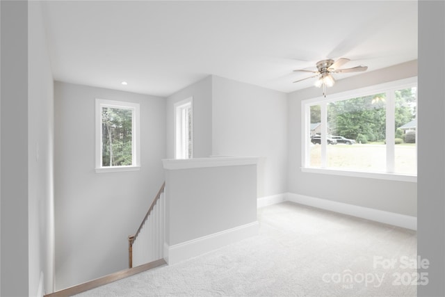 empty room featuring carpet flooring and ceiling fan