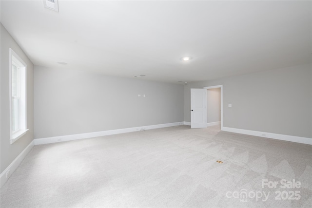 carpeted spare room featuring a healthy amount of sunlight