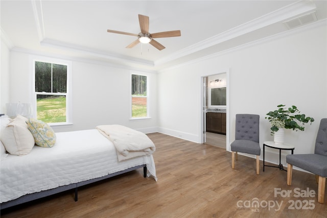 4257 Candlewood Dr Unit 7, Sherrills Ford, NC 28673 - bedroom featuring a tray ceiling, ornamental molding, wood finished floors, multiple windows, and connected bathroom