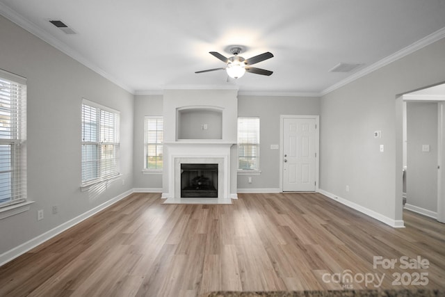 unfurnished living room featuring ceiling fan, wood-type flooring, and ornamental molding