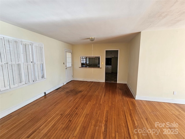 unfurnished living room with hardwood / wood-style flooring