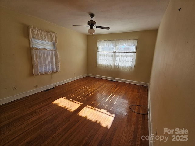 empty room featuring ceiling fan and hardwood / wood-style floors