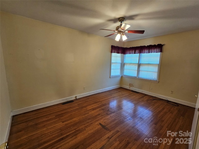 unfurnished room featuring ceiling fan and dark hardwood / wood-style flooring