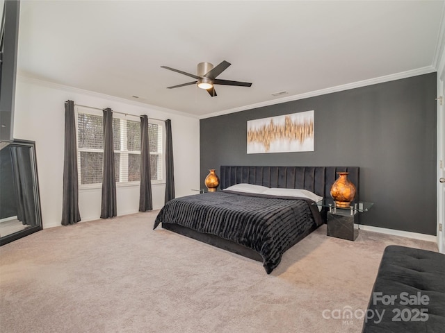 carpeted bedroom featuring ceiling fan and ornamental molding