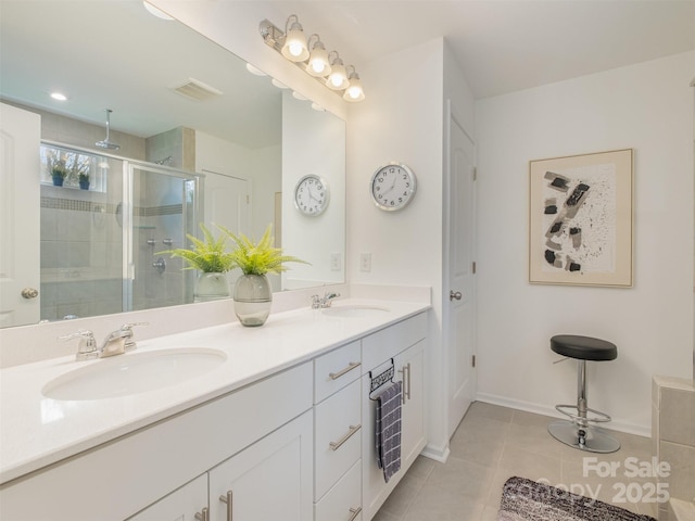 bathroom featuring vanity, tile patterned floors, and an enclosed shower