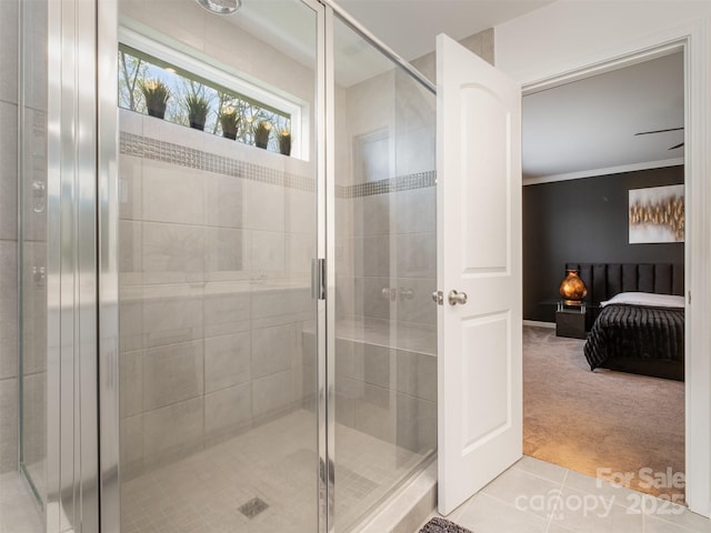 bathroom featuring tile patterned flooring, a shower with door, and ornamental molding