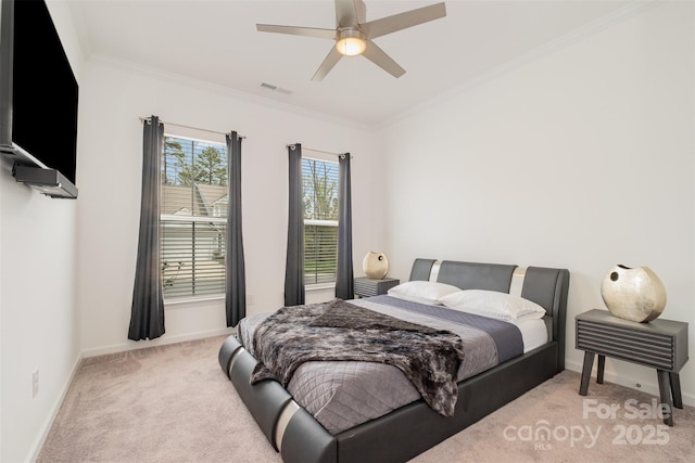 carpeted bedroom featuring ceiling fan and ornamental molding