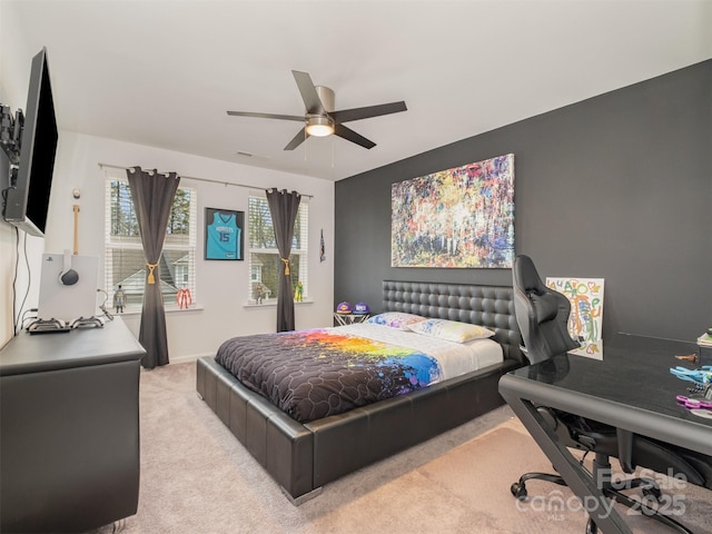 bedroom featuring ceiling fan and light carpet