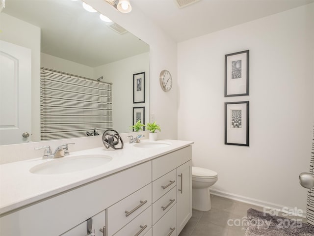 bathroom featuring toilet, vanity, a shower with curtain, and tile patterned flooring