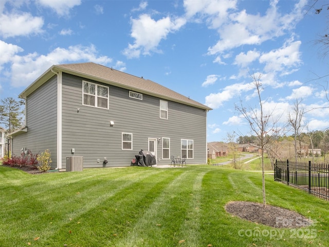 back of house with a patio, a lawn, and central air condition unit