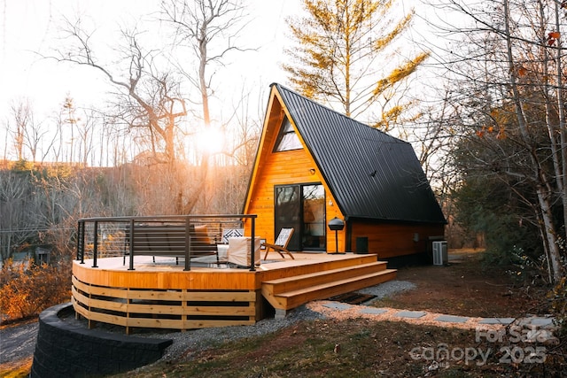 rear view of house featuring a wooden deck and cooling unit