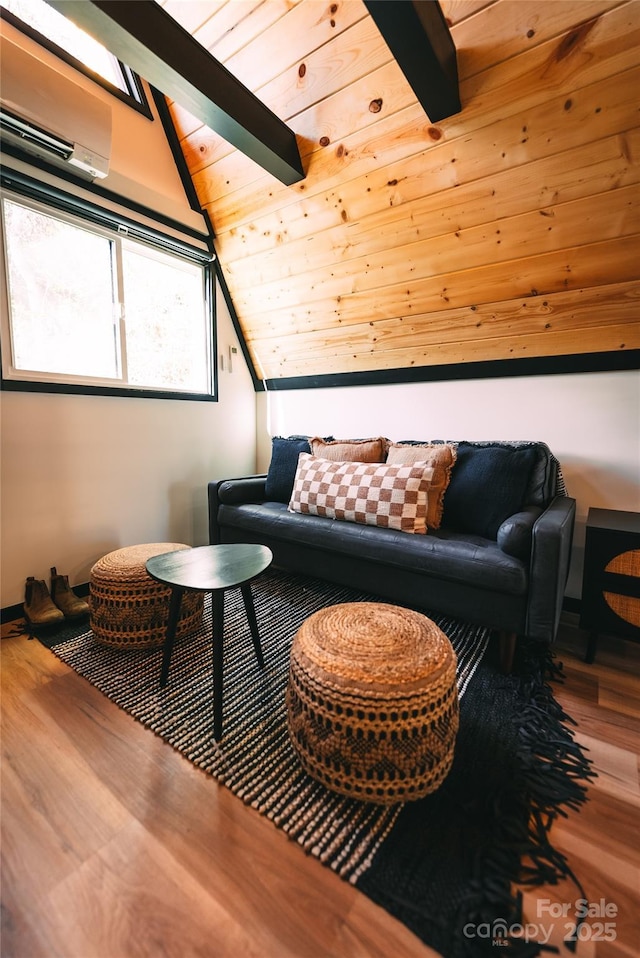 sitting room featuring hardwood / wood-style flooring, wooden ceiling, a wall mounted air conditioner, and vaulted ceiling with beams