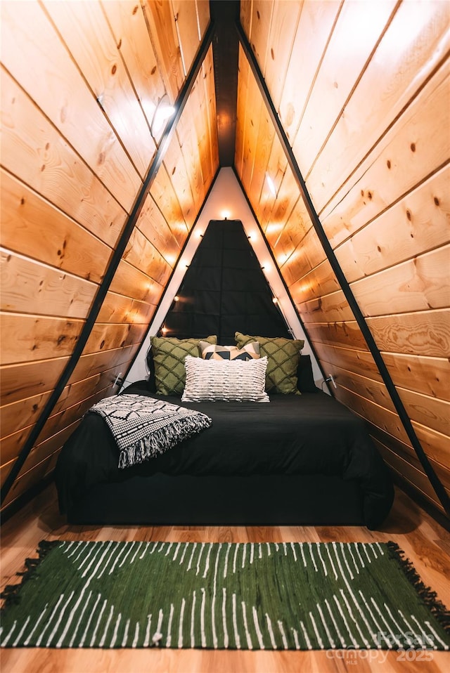 unfurnished bedroom with hardwood / wood-style flooring, vaulted ceiling, and wooden ceiling