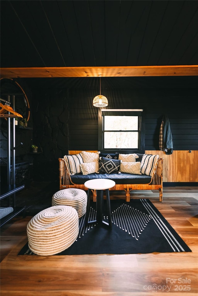 interior space with hardwood / wood-style floors and wood walls