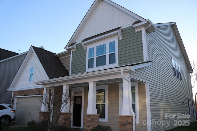 craftsman-style home featuring covered porch and a garage