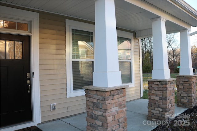 entrance to property featuring covered porch