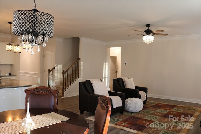 dining space featuring dark wood-type flooring, ornamental molding, and ceiling fan