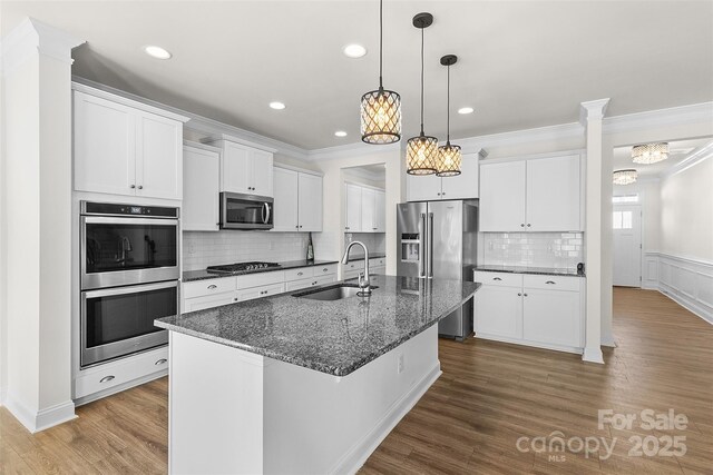 kitchen featuring sink, white cabinets, a kitchen island with sink, stainless steel appliances, and light hardwood / wood-style flooring